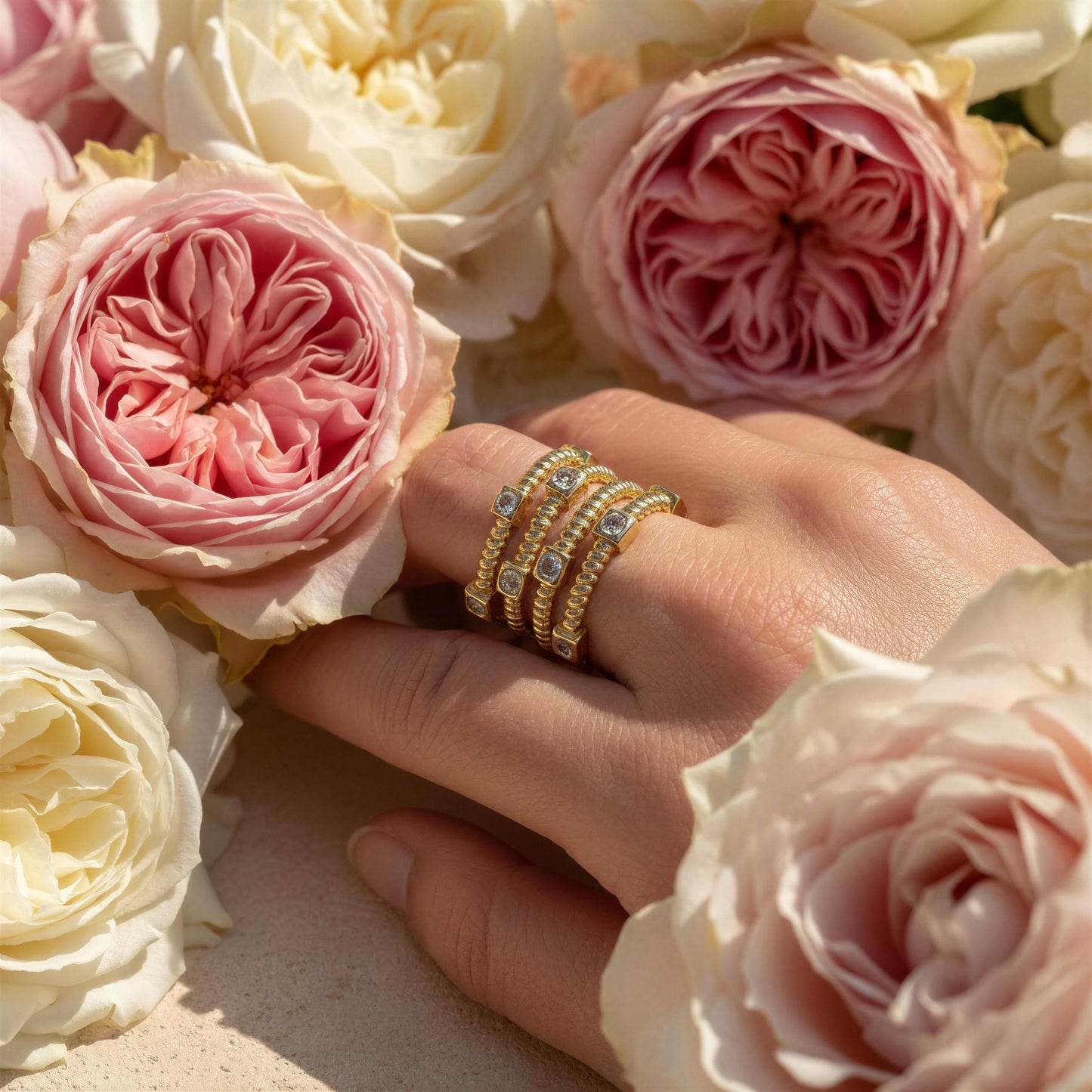 Woman wearing the Intreccio Ring along flowers