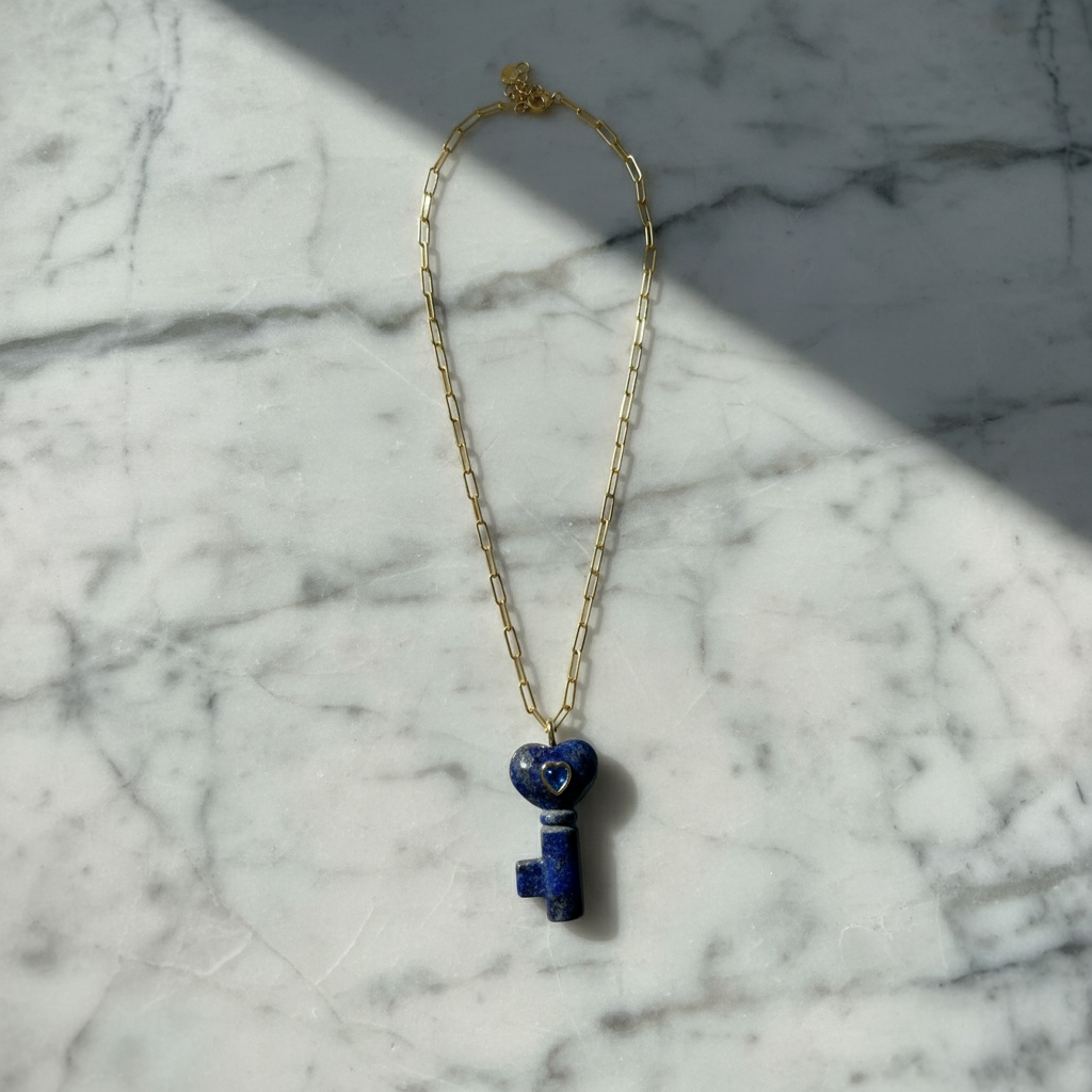 La Vita Key — Lapis Lazuli with a blue key-shaped pendant on a marble surface