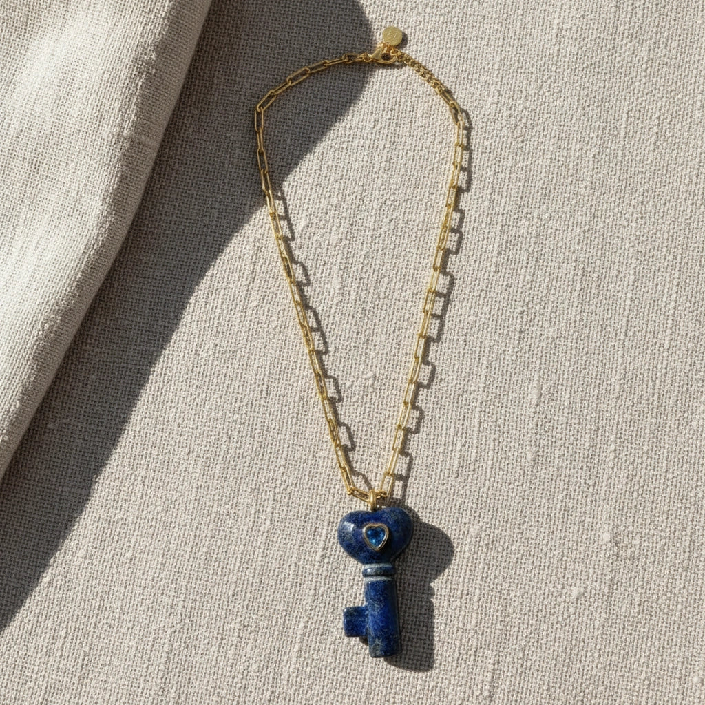 La Vita Key — Lapis Lazuli on a textured beige surface