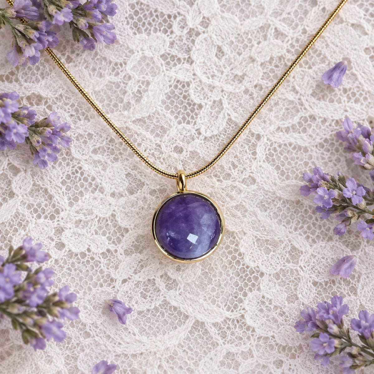 Lavanda Necklace from Chica Chica Jewelry against a white lace fabric with lavender figs. 