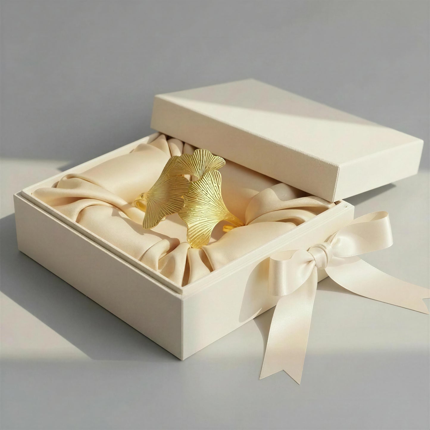 The Leaf of Eternity Cuff Bracelet from Chica Chica Jewelry in a beige box with ribbon.