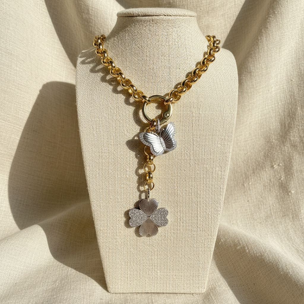 Lucky Flutter Slip-On Necklace - Gold and silver necklace with butterfly pendants on a beige mannequin bust.