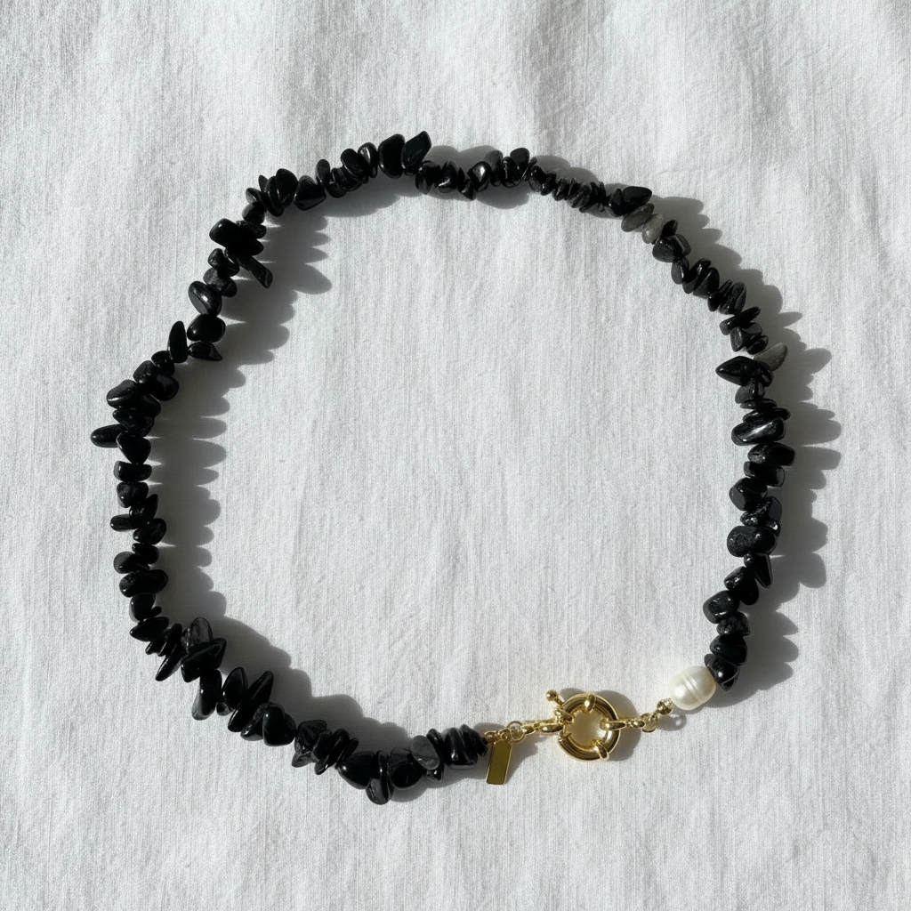 Midnight Tide Necklace with a gold clasp on a white background