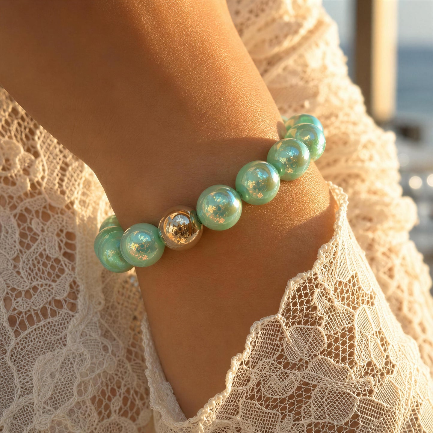 Close-up of a person wearing the Mint Glow Bracelet against a blurred background.