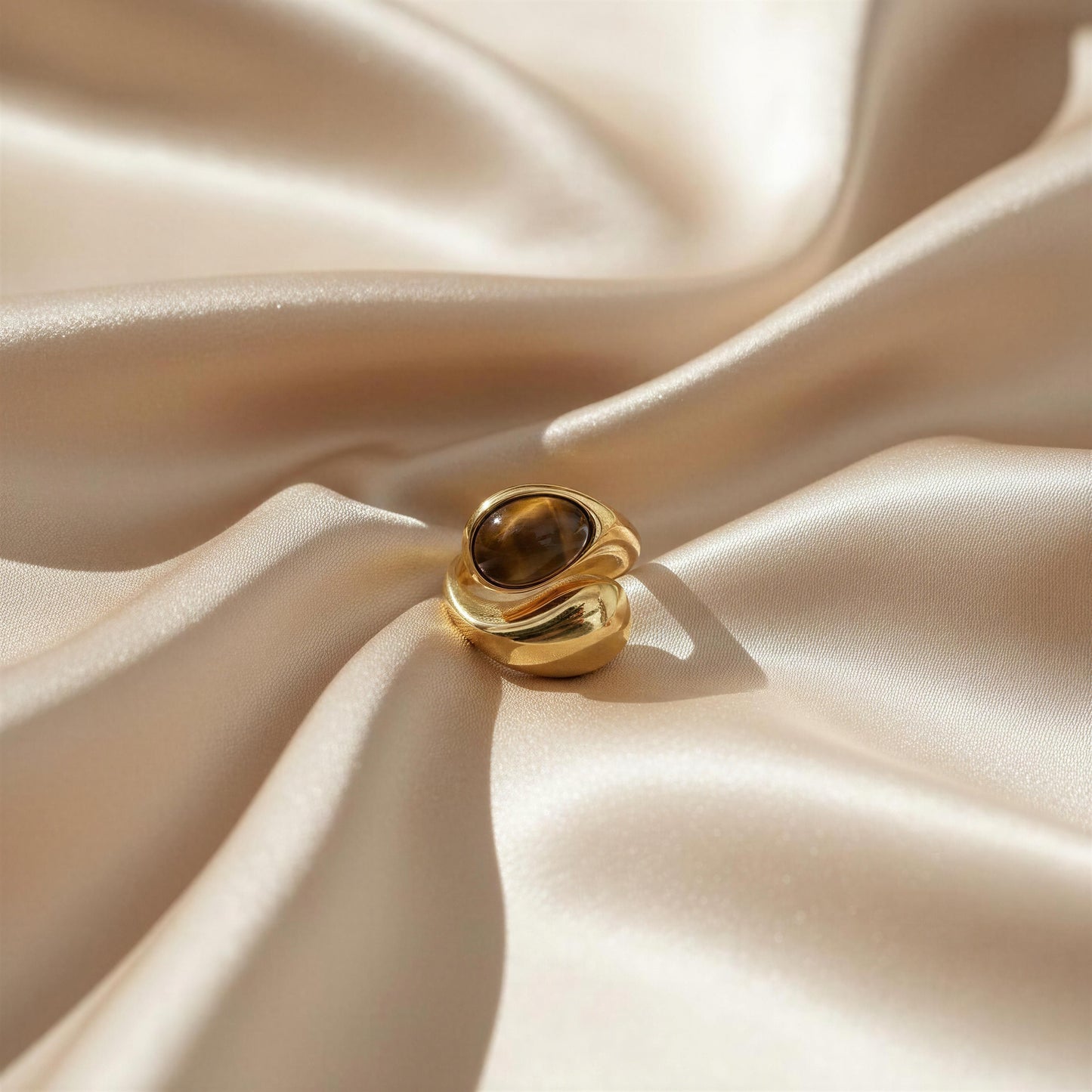 The Molten Terra Ring on beige satin fabric