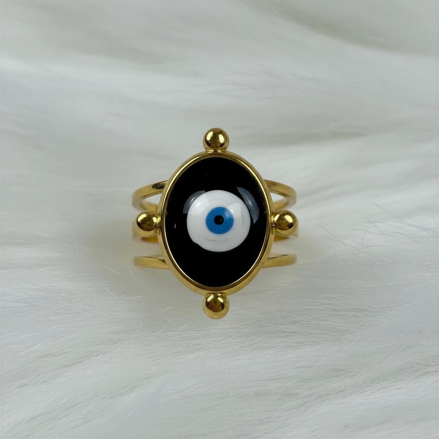 The Nazar Aura Ring on a white fabric background