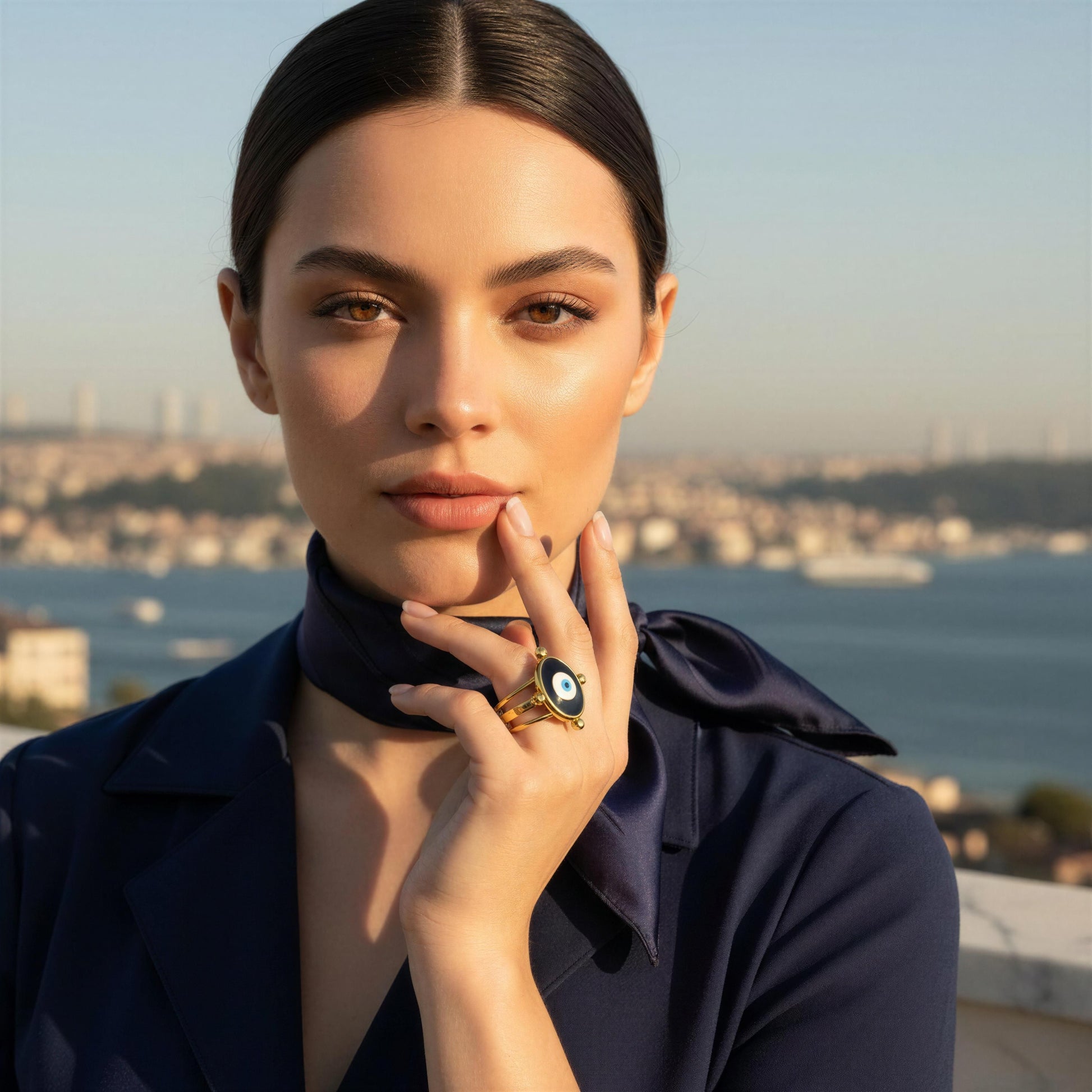 Woman wearing a dark blue outfit with a cityscape in the background