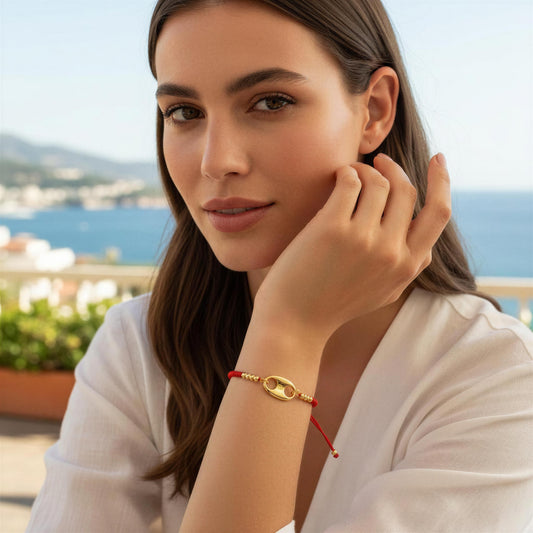 Woman wearing the  Nexo Bracelet – Red against a scenic background.