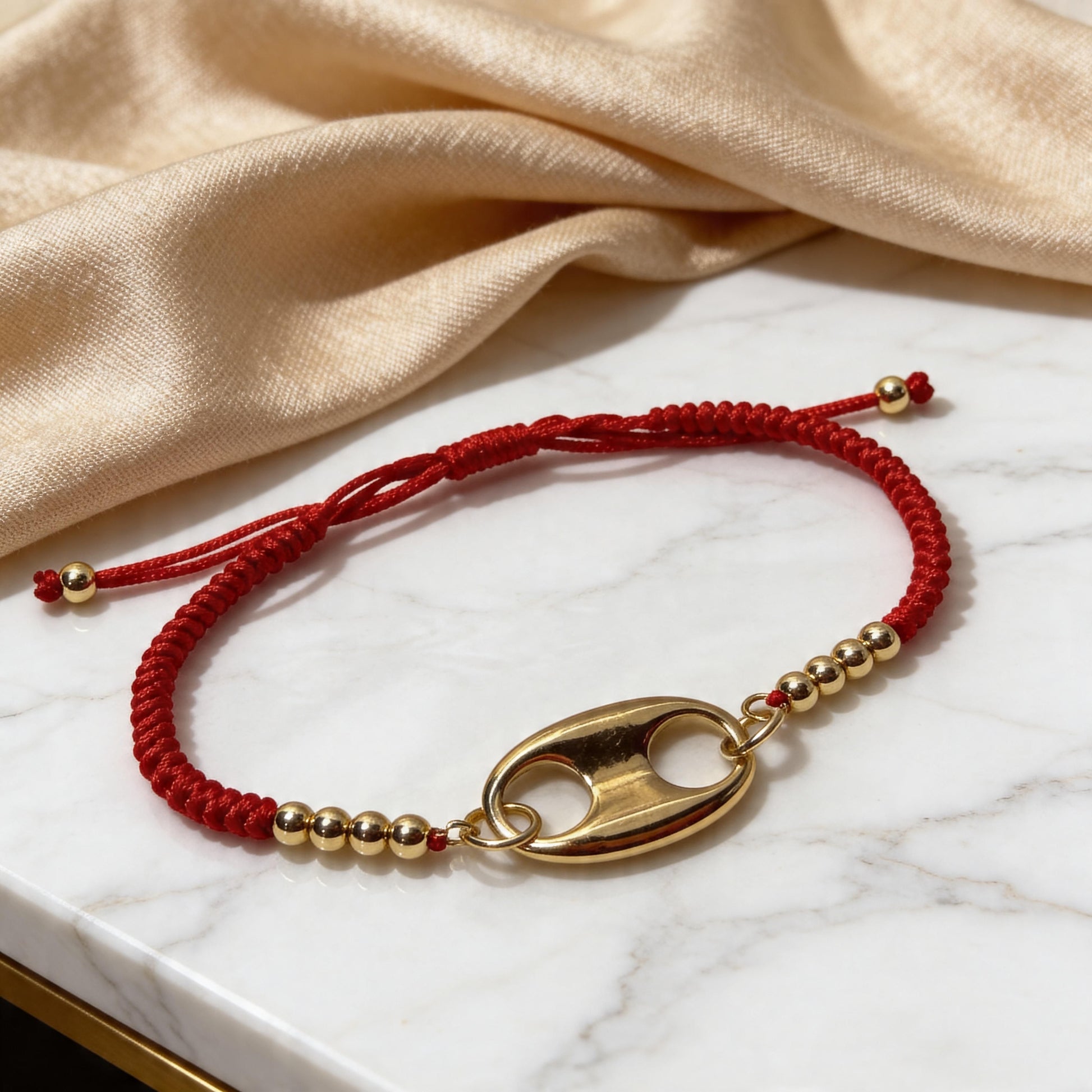 The Nexo Bracelet – Red on a marble surface