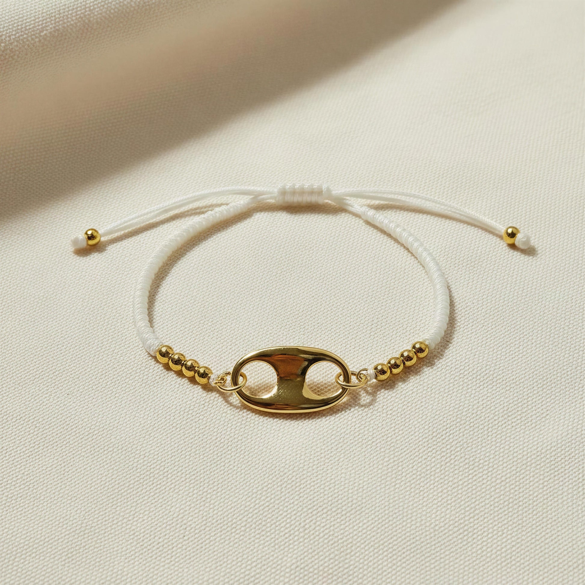 The Nexo Bracelet – White with a white cord on a beige background