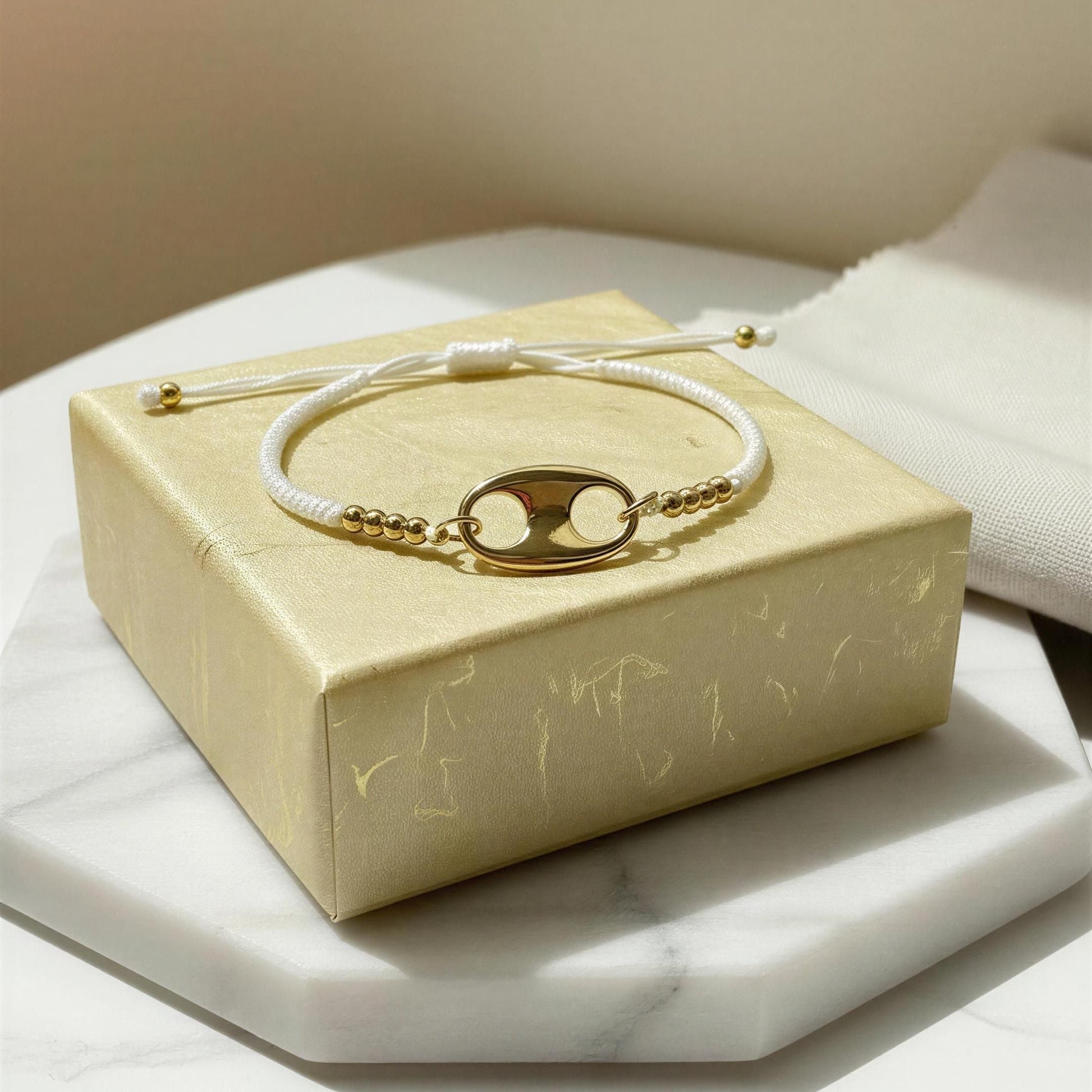 The Nexo Bracelet – White on a branded box with a soft focus background