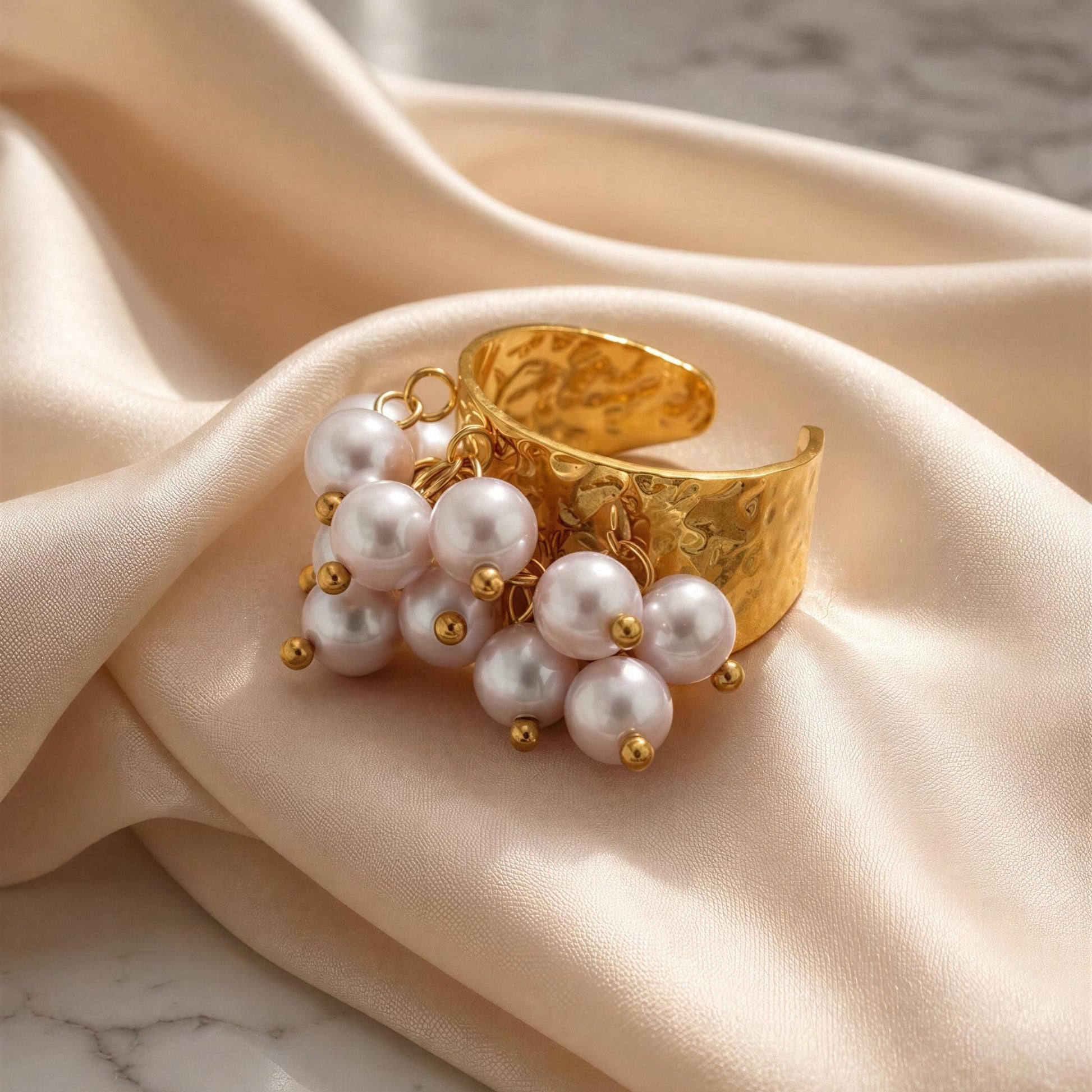 The Ocean Pearl Bloom Ring against silk fabric 