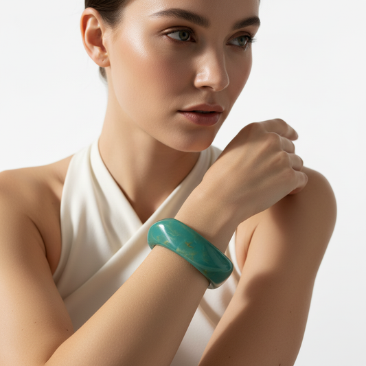 Woman wearing the Ocean Twist Bangle- turquoise bracelet on a plain background