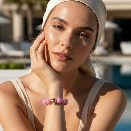 Woman wearing a headscarf and pink bracelet outdoors
