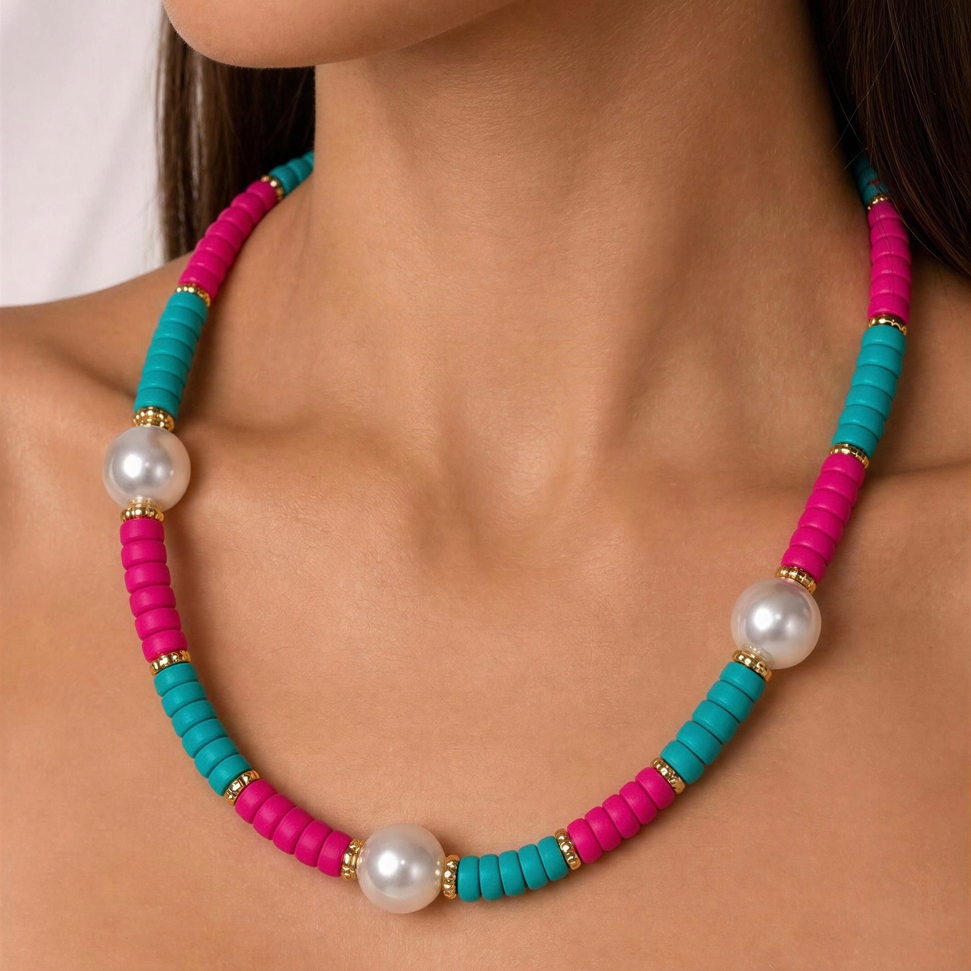 Necklace with pink and blue beads and pearls on a person