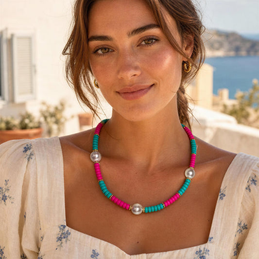 Woman wearing the Persiana Necklace with a Mediterranean scenic background
