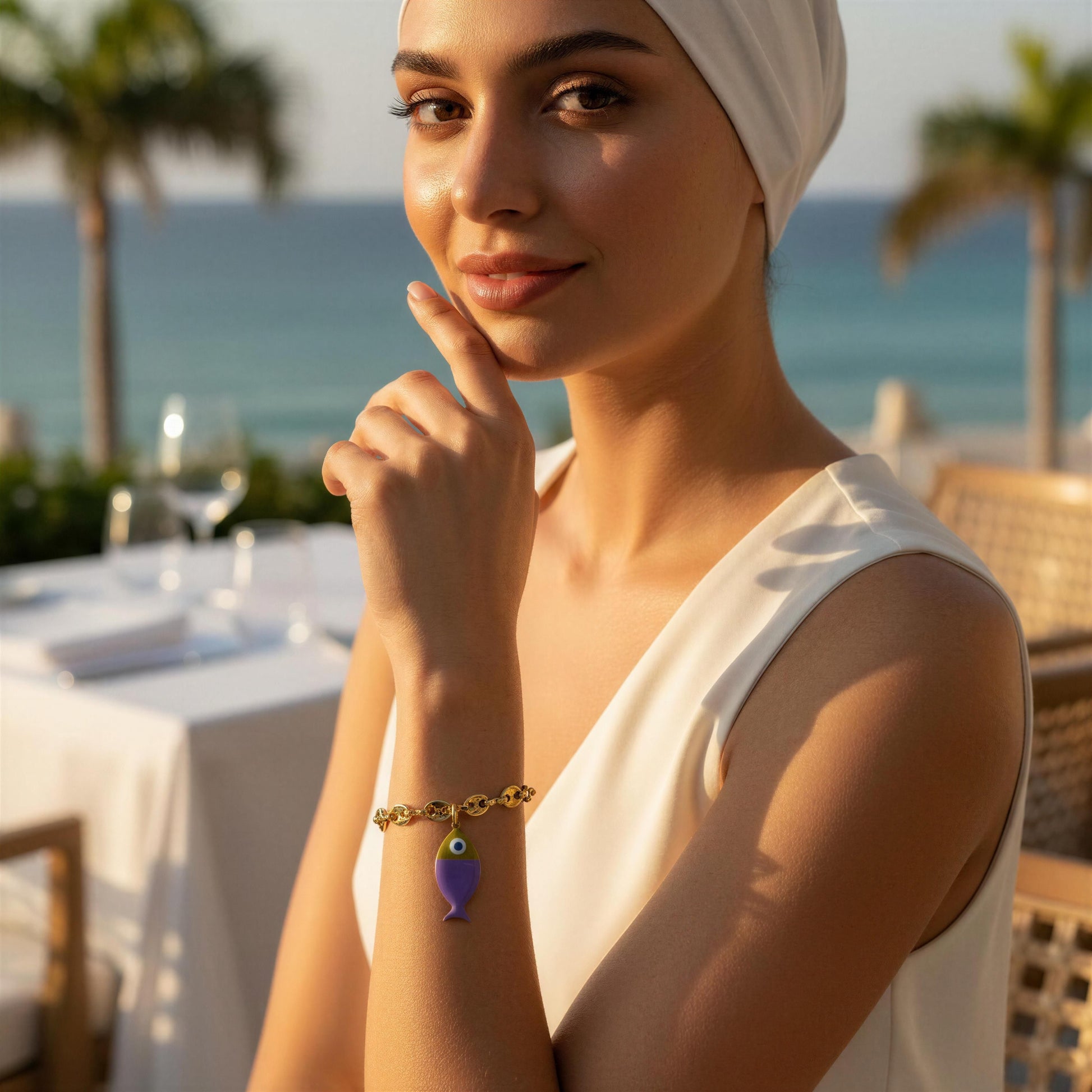 Woman with a headscarf and the Pesca Lila Bracelet by the ocean