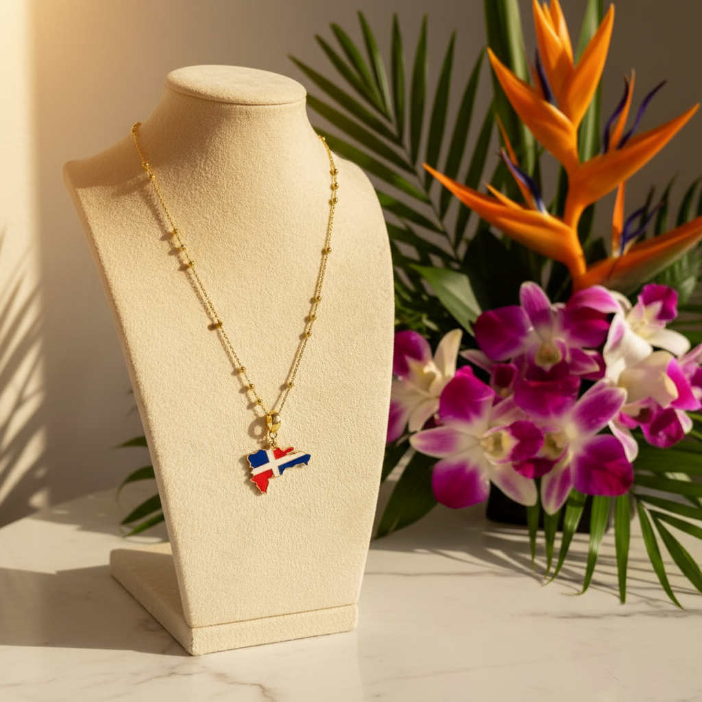 The Quisqueya Necklace from Chica Chica Jewelry with the Dominican Republic flag pendant on a beige stand, surrounded by flowers and leaves.