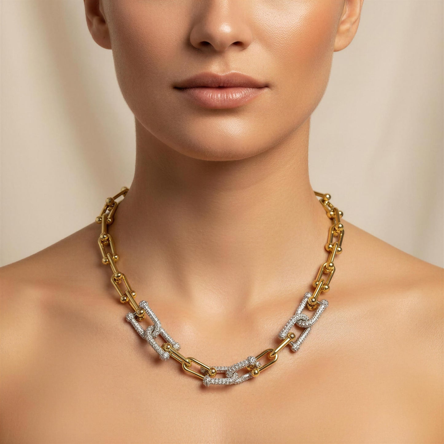 Gold chain necklace on a model against a neutral background