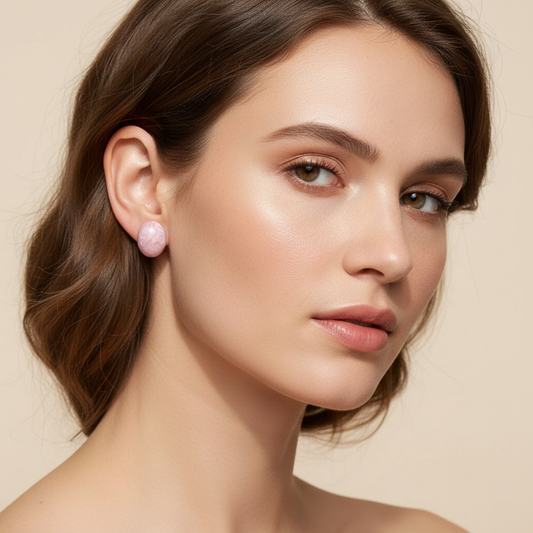 Woman wearing pink earrings against a beige background