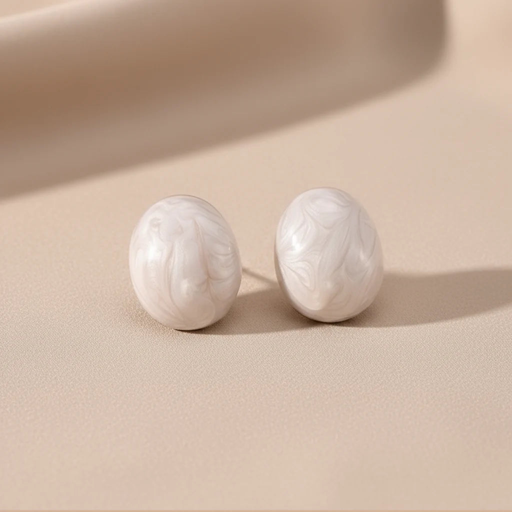 Rosina Studs in Ivory Mist displayed as a pair, ivory marbled stud earrings on neutral background
