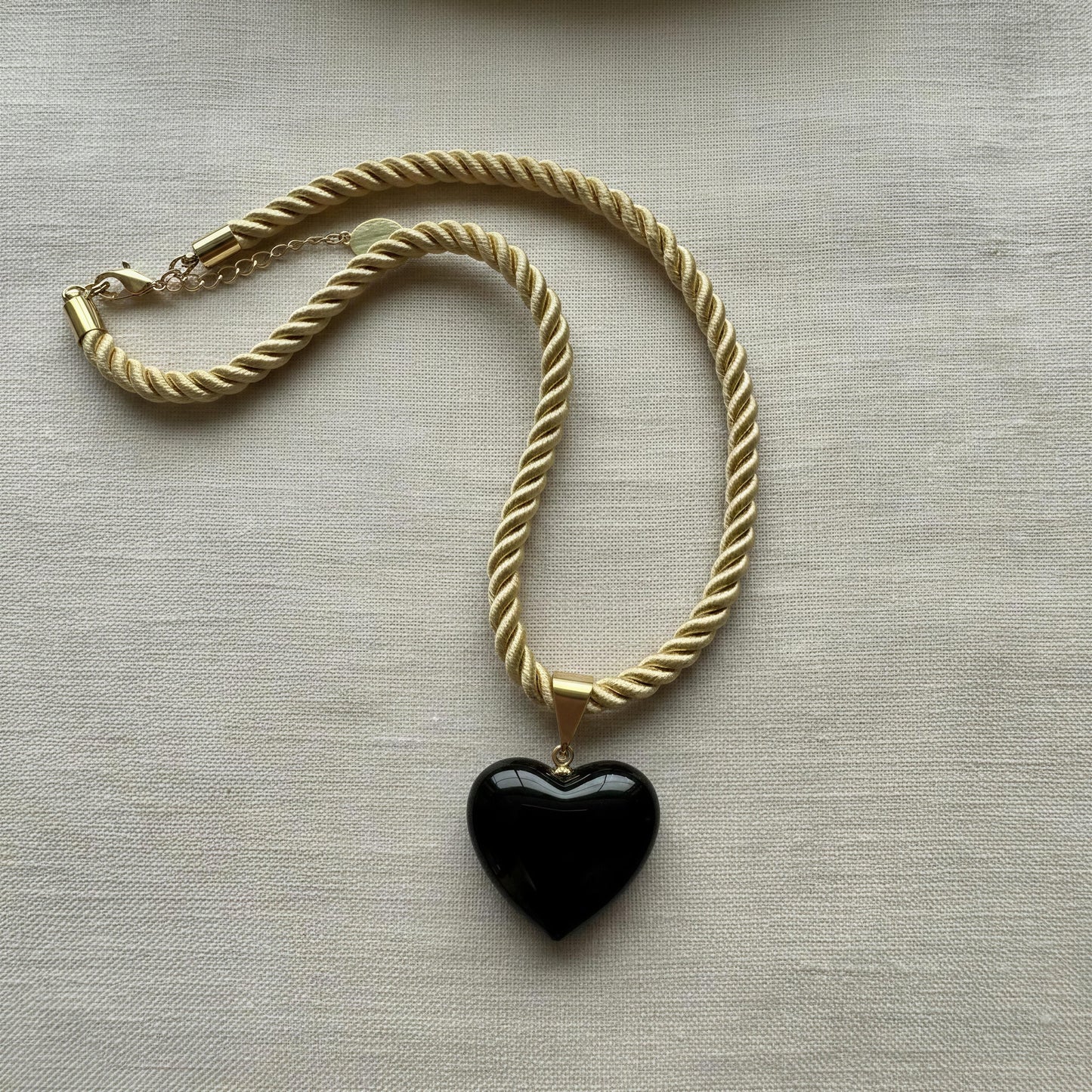 Close-up of the Siyah Murano-style black heart necklace from Chica Chica Jewelry.