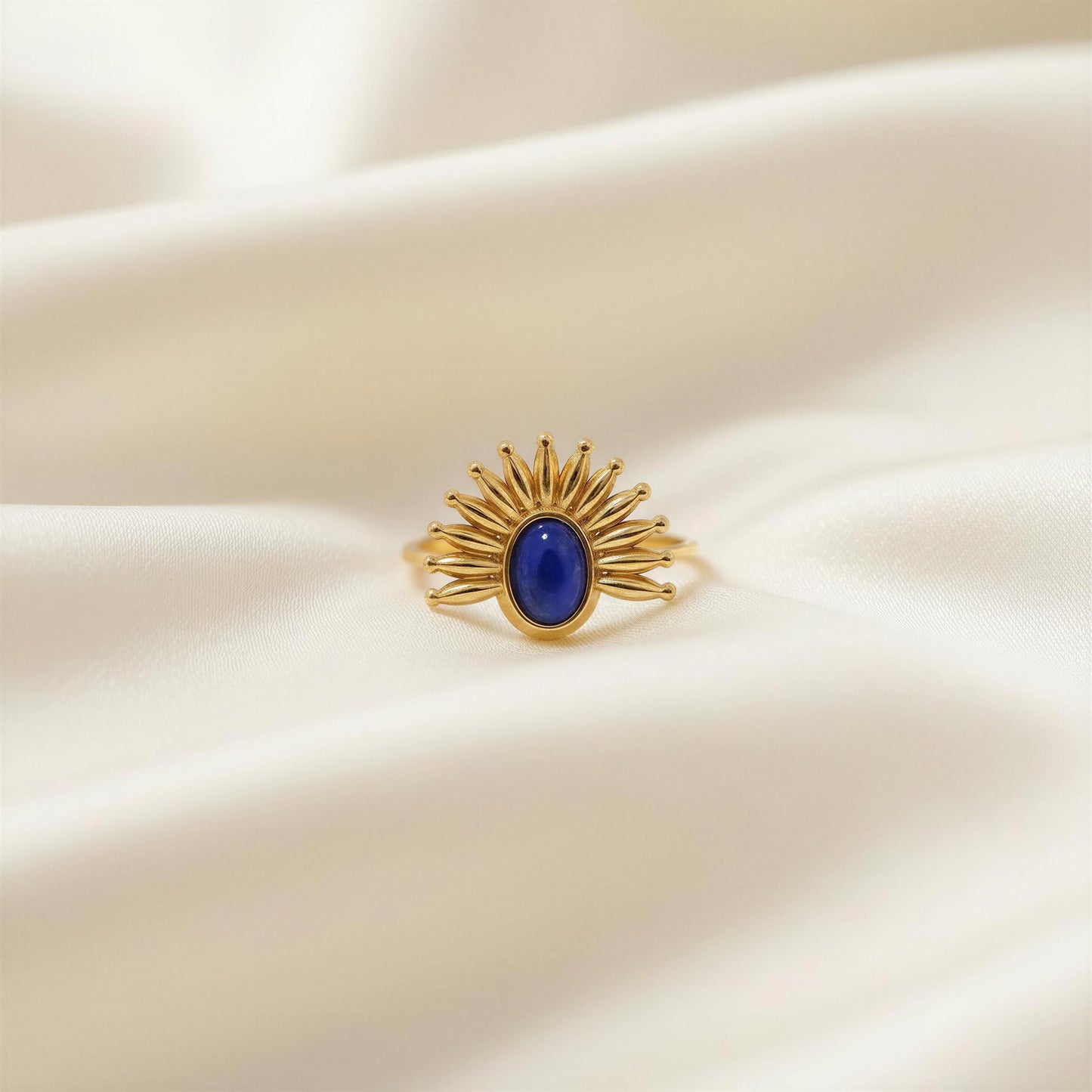The Solara Ring on a beige fabric background