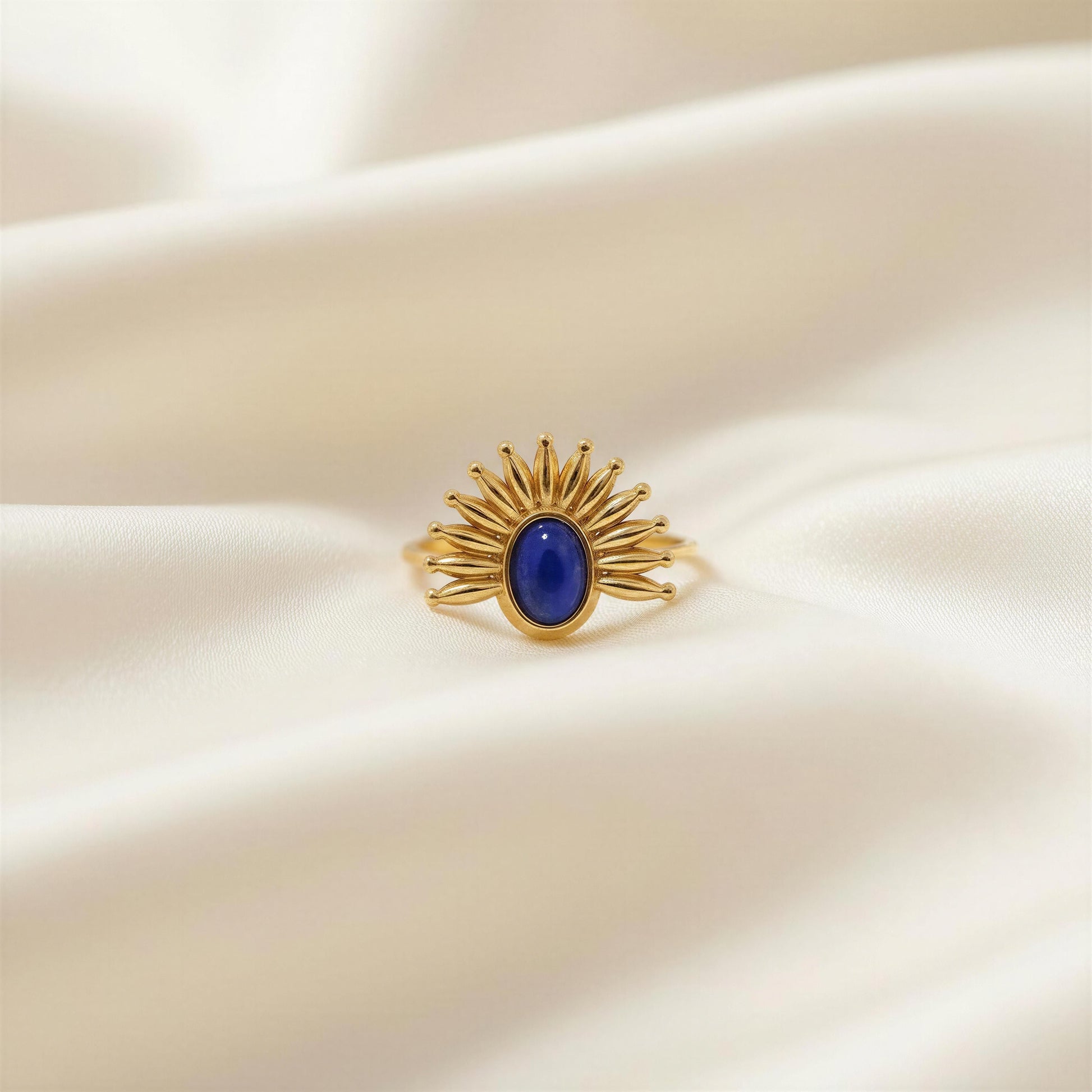 The Solara Ring on a beige fabric background