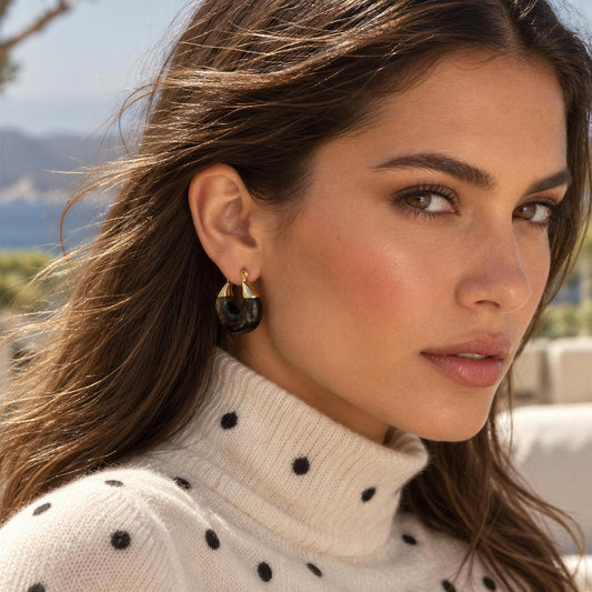 Model wearing the Soraya Hoops – Black from  Chica Chica Jewelry and a cashmere polka dot turtleneck 