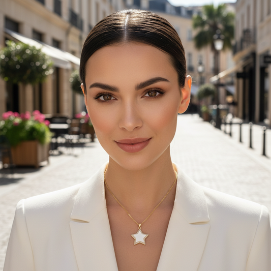 Woman wearing a white blazer and star-shaped necklace on a city street.