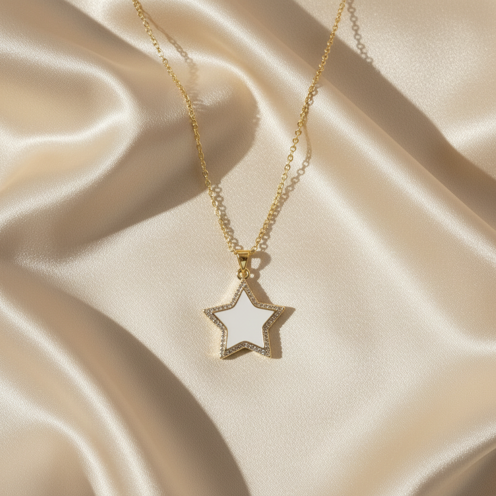 Gold star-shaped pendant necklace on a beige satin background