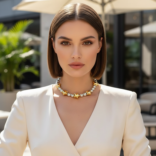 Model wearing a gold and silver star bead bracelet styled with a cream outfit, showcasing an elegant layered bracelet design.