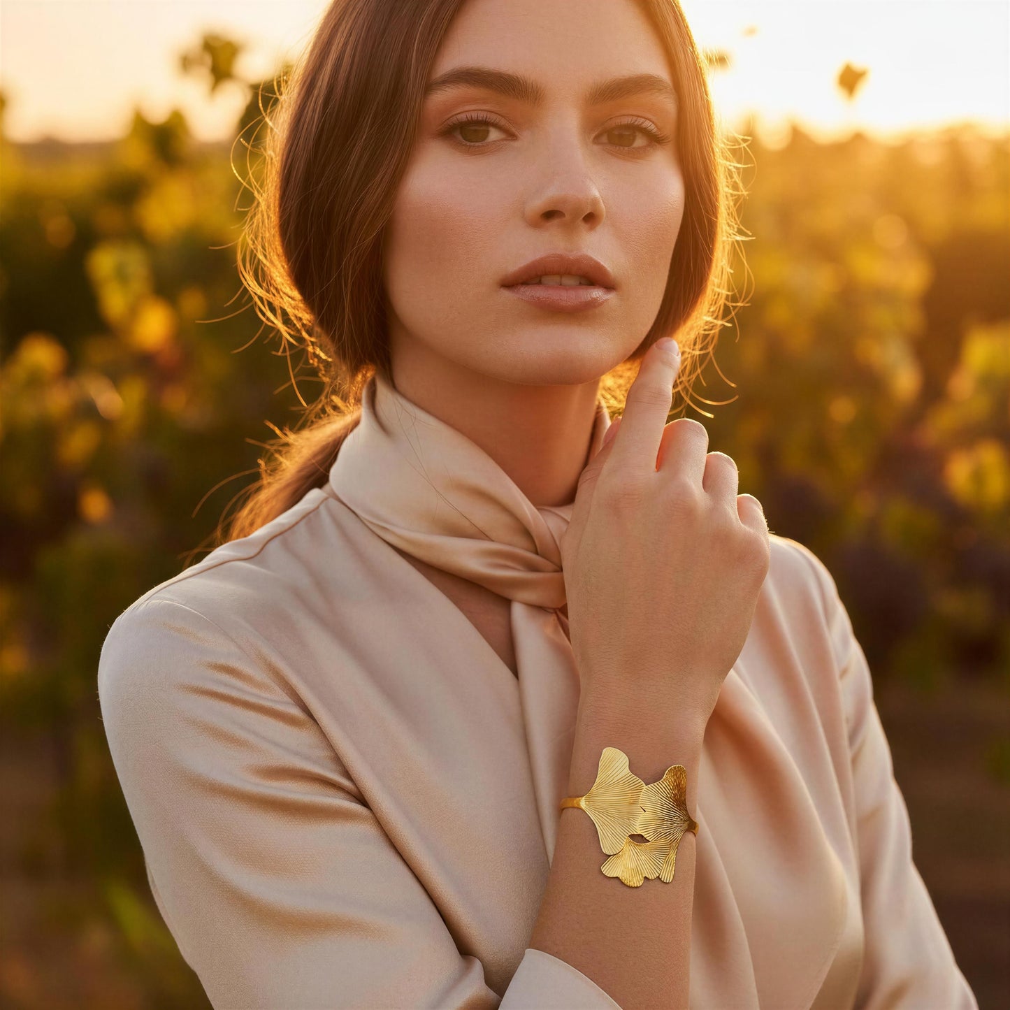 Woman wearing the Leaf of Eternity Cuff Bracelet
 in a scenic outdoor setting