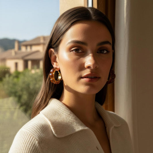 Woman wearing large hoop earrings with a scenic background