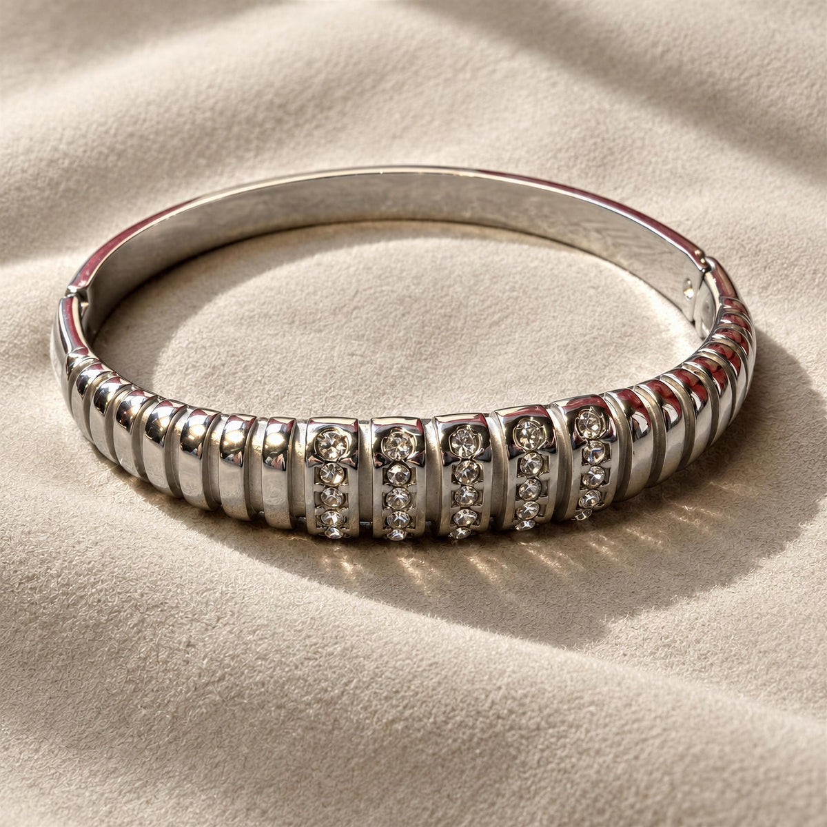 The Alessia Bangle from Chica Chica Jewelry against suede fabric 