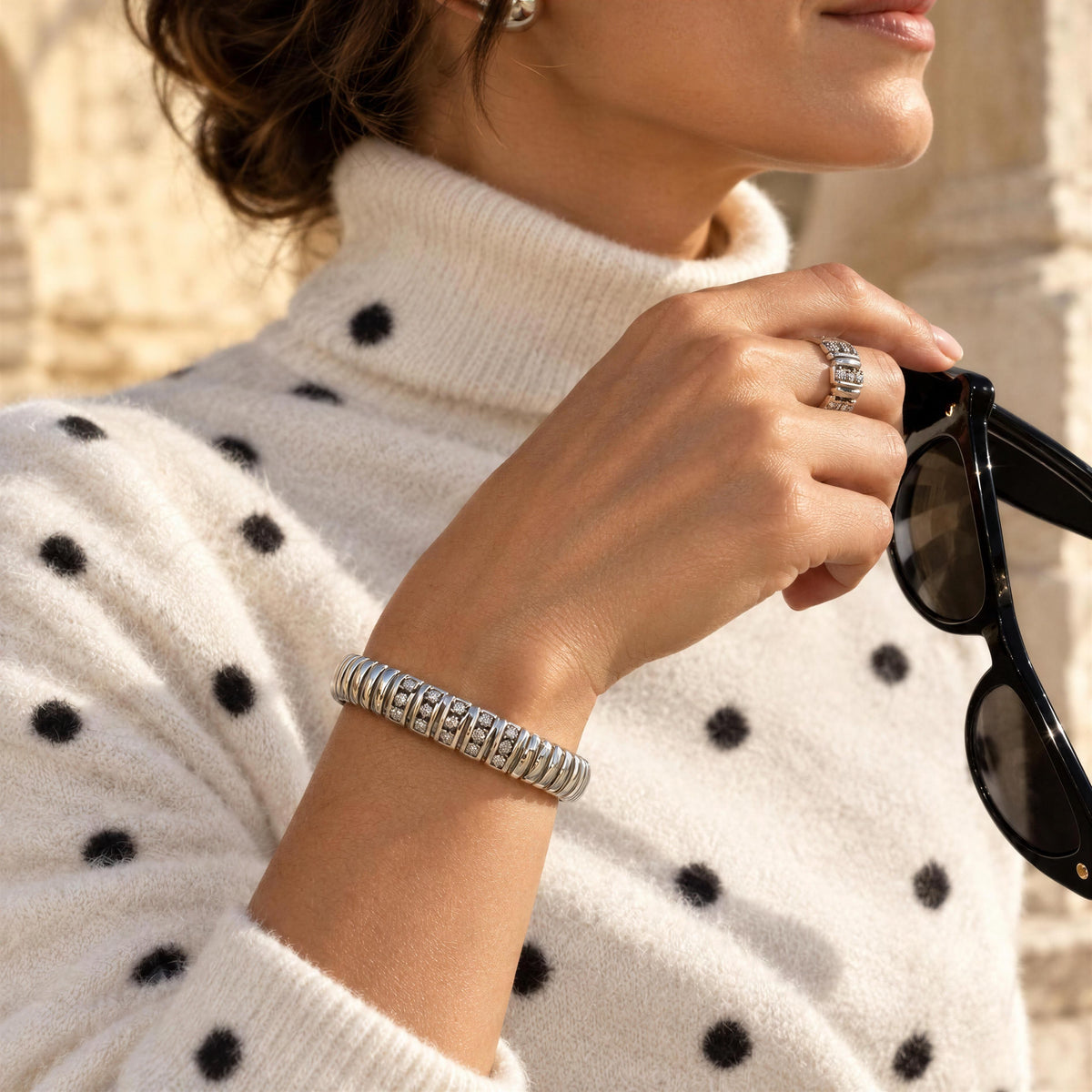 Model wearing a cashmere polka dot turtleneck and the The Alessia Bangle from Chica Chica Jewelry 