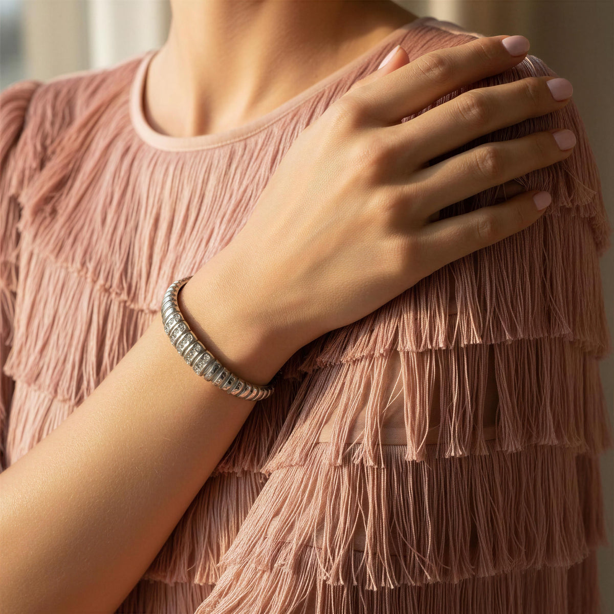 Model wearing a blush color fringes dress and the Alessia Bangle  from Chica Chica Jewelry 