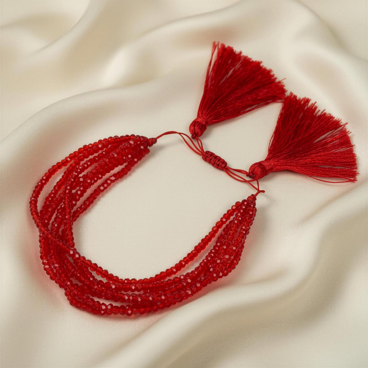 Amarra Bracelet with tassels on a beige fabric background