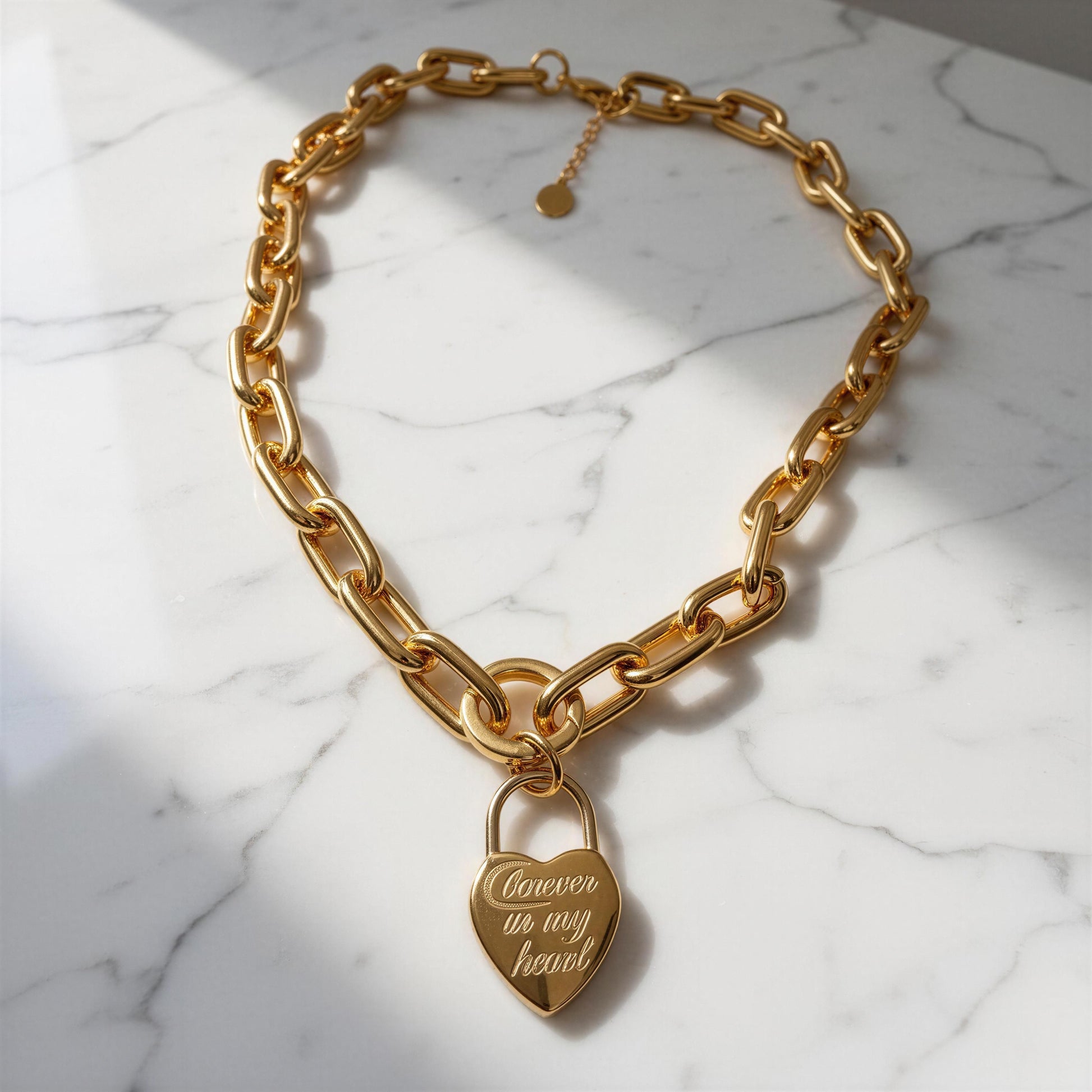 The Amore Lock Necklace on a marble surface