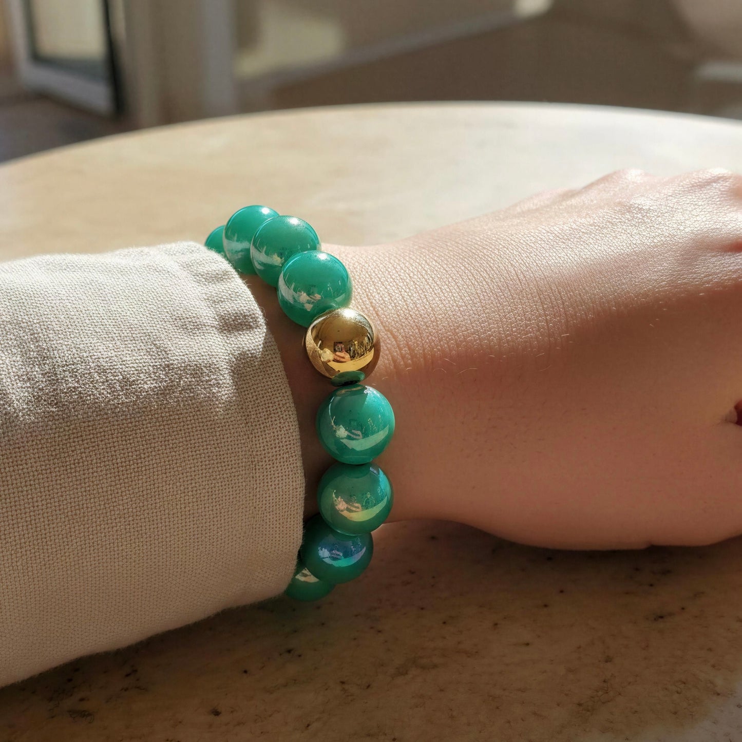The Aquamarine Glow Bracelet on a wrist, against a neutral background.