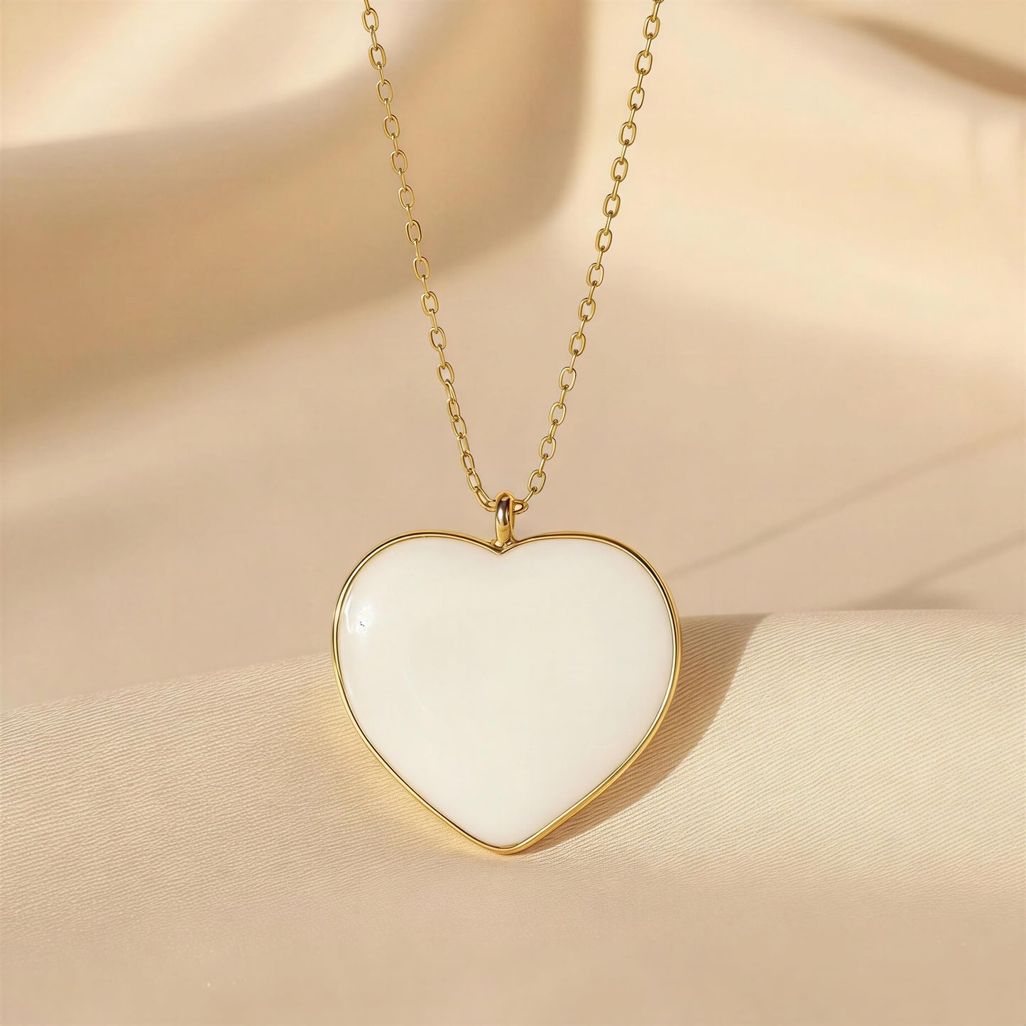 Heart-shaped pendant necklace on a beige fabric background