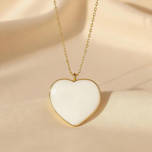 Heart-shaped pendant necklace on a beige fabric background