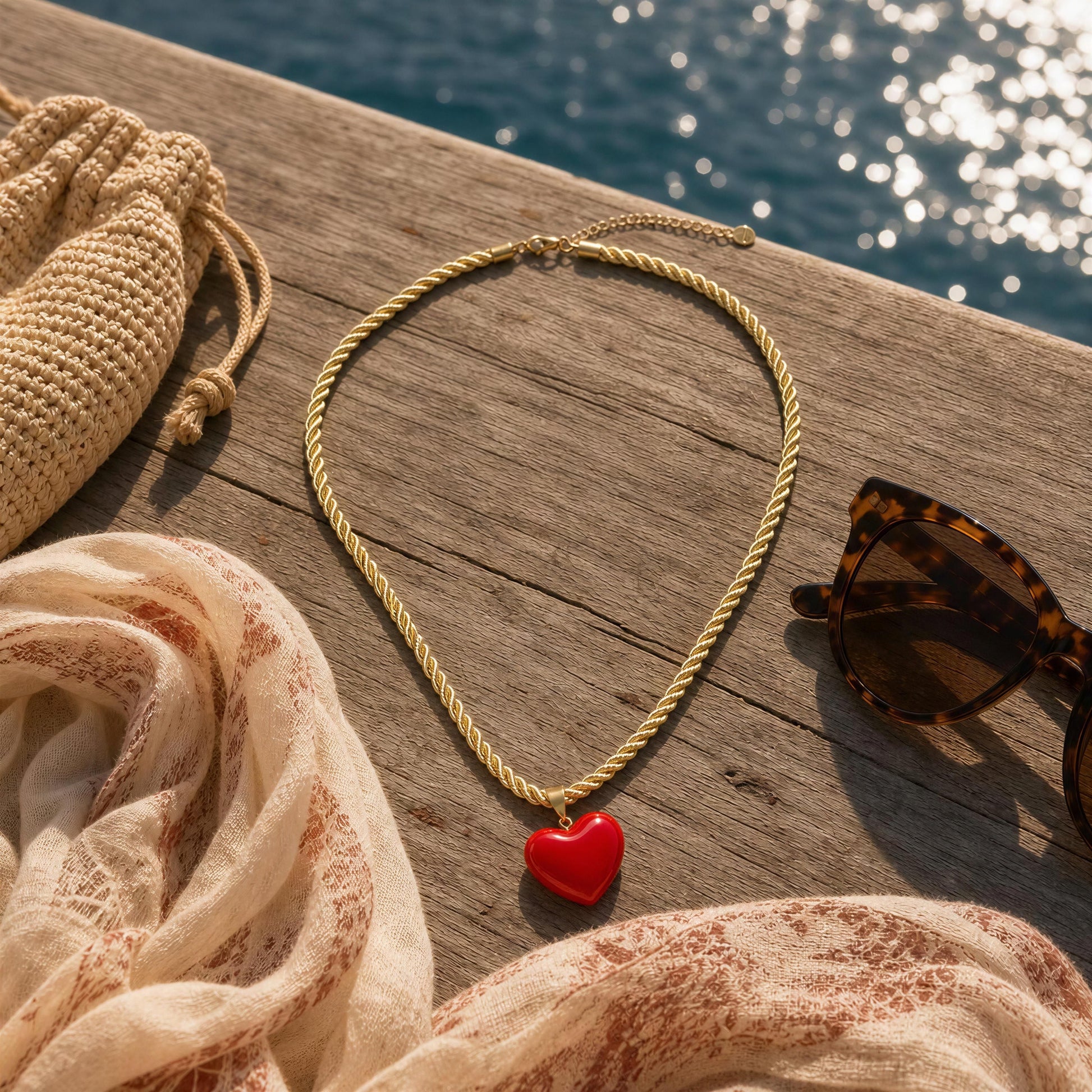 The Corallo Necklace by Chica Chica Jewelry flat lay by seaside.