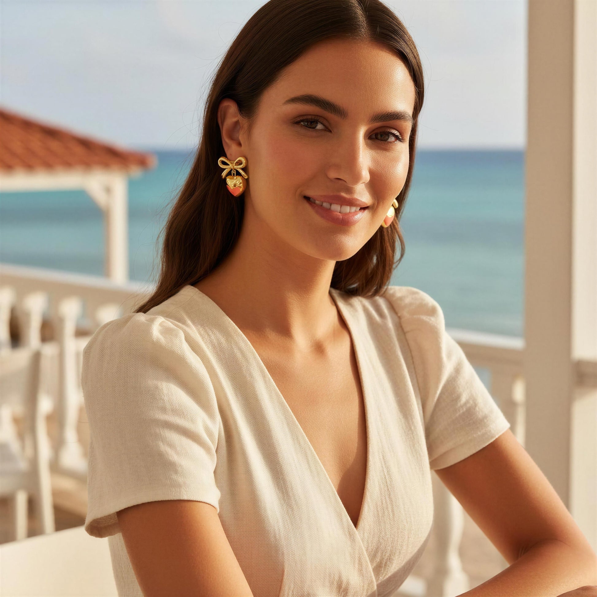 Model wearing the Cupid's Knot Earrings in Gold at Caribbean terrace 