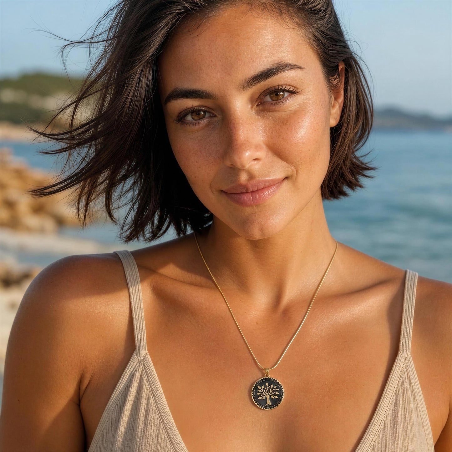 Woman with the  Eternal Tree Black Medallion Necklace standing by the water