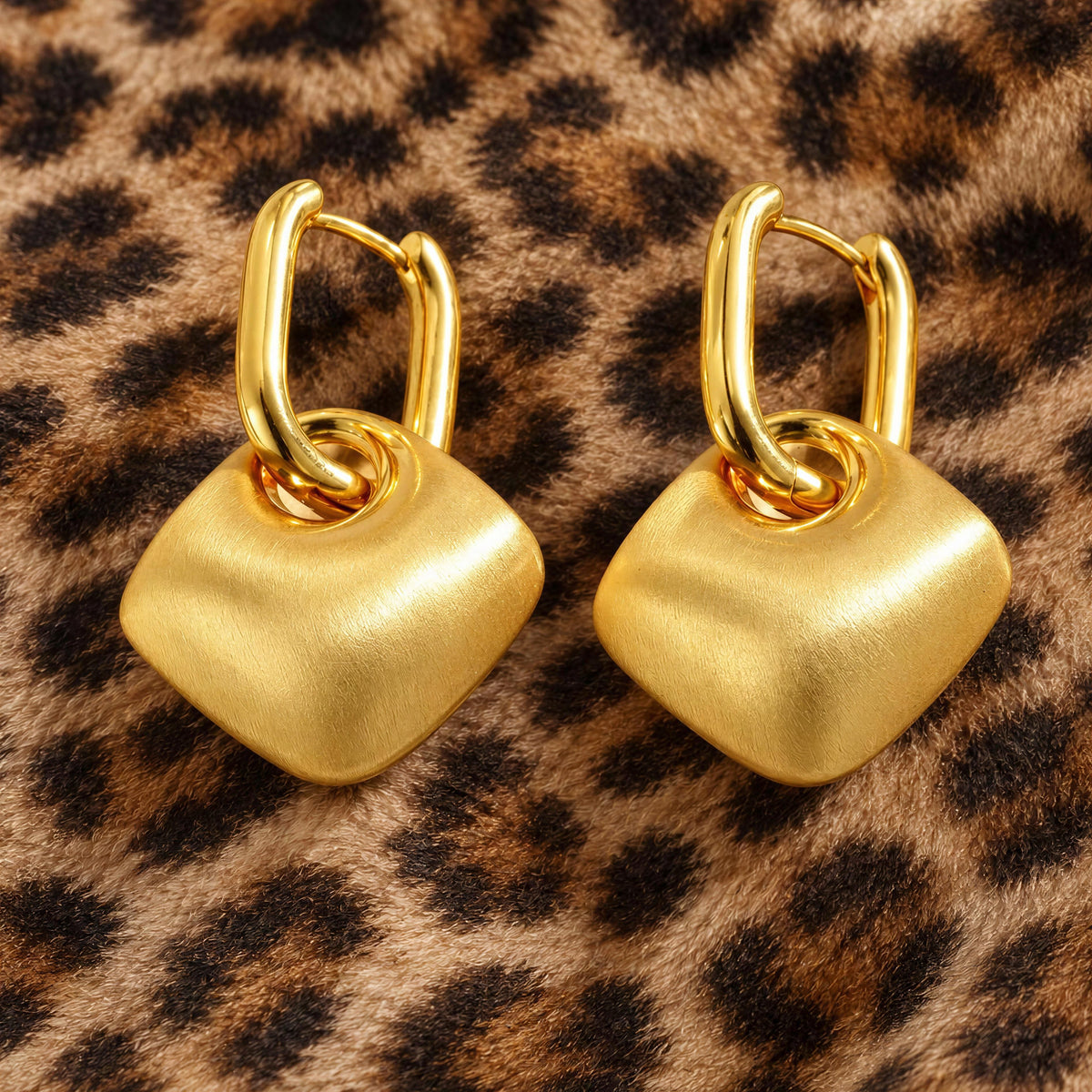 The Farrah Earrings,  Chica Chica Jewelry against animal print fabric.
