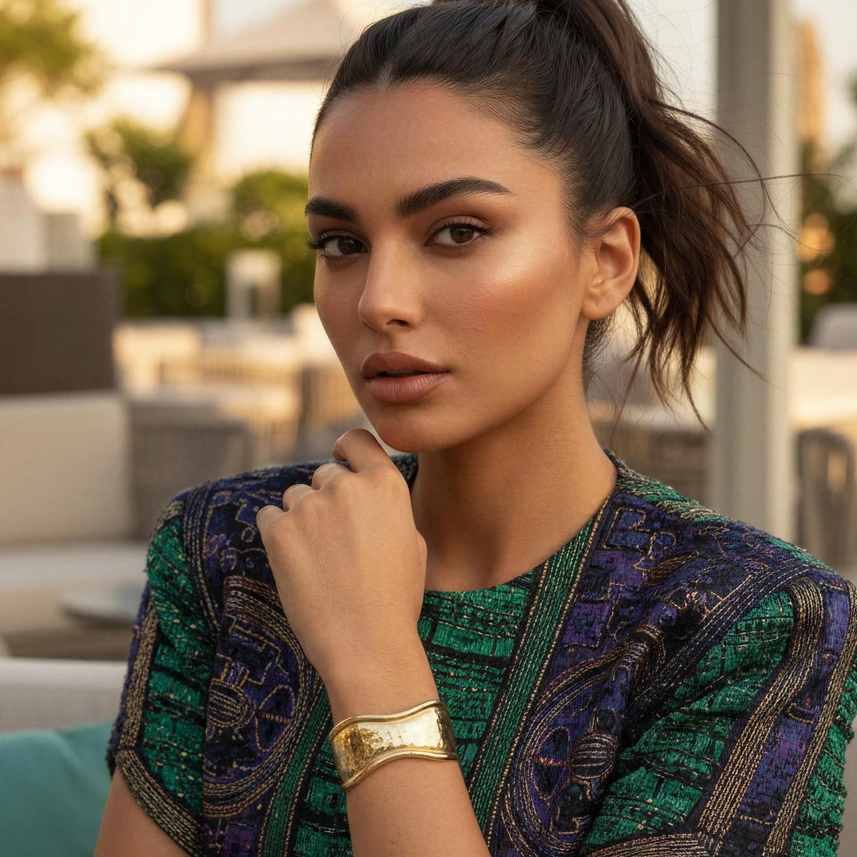 Forma Gold statement cuff styled with a patterned jewel-tone blouse
