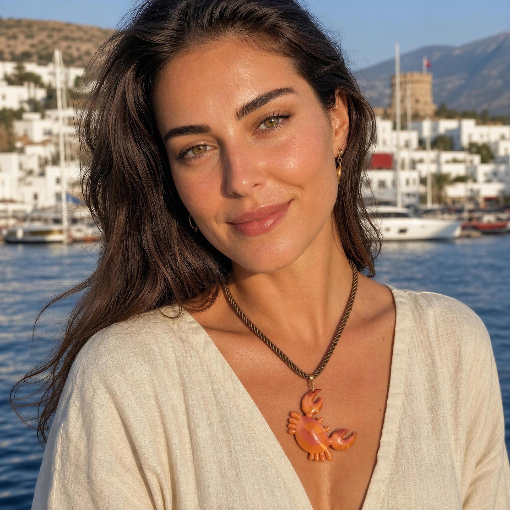 Women wearing the Granchio Necklace from Chica Chica Jewelry by Mediterranean Sea.
