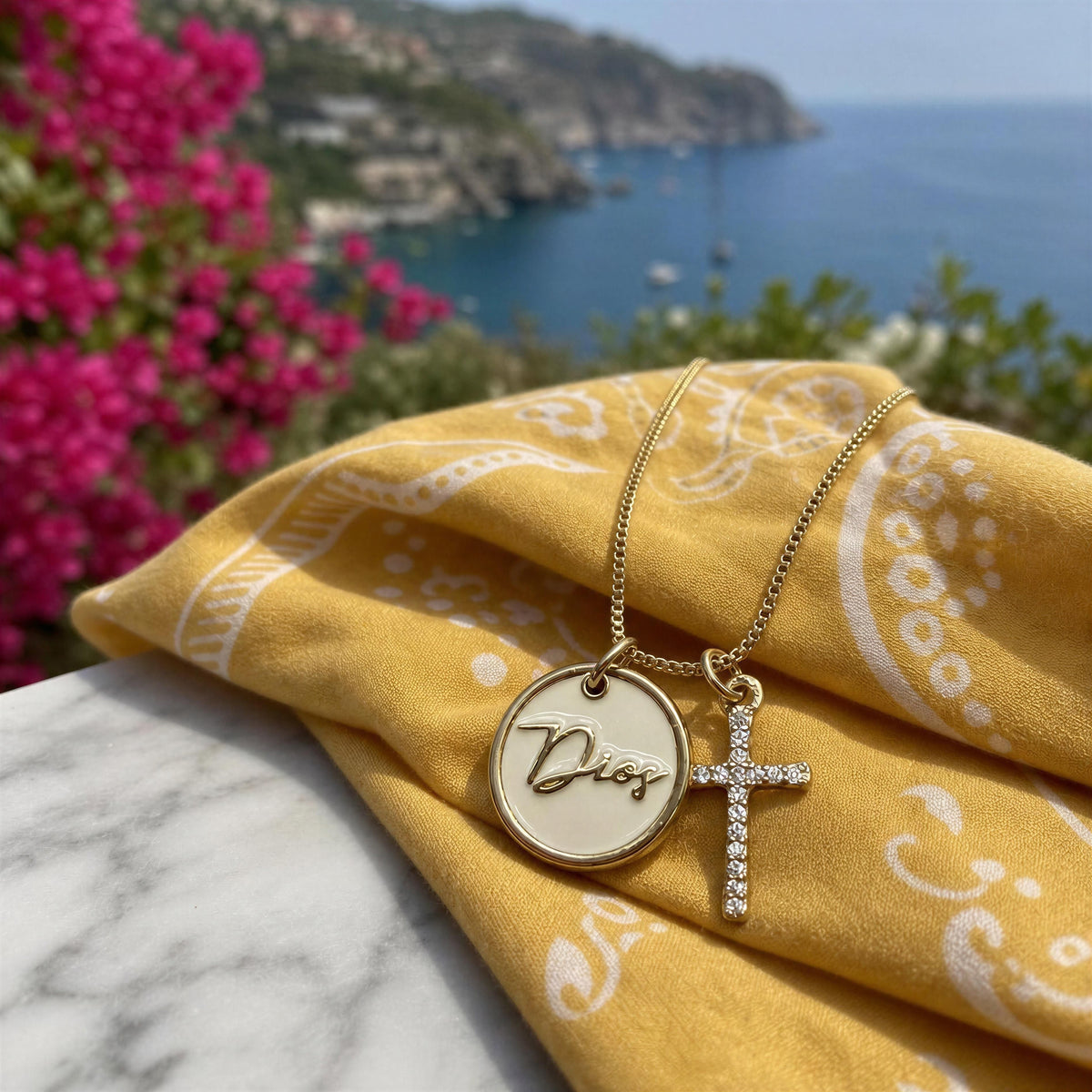 The Grazia Necklace- Chica Chica Jewelry against a yellow bandanna by Mediterranean Sea.