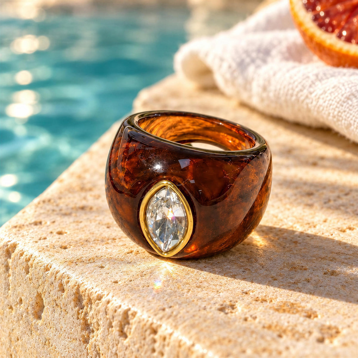 The Lola_Ring_Toffee-_Chica_Chica_Jewelry- Retro Glam Collection set outdoors by pool ledge. 